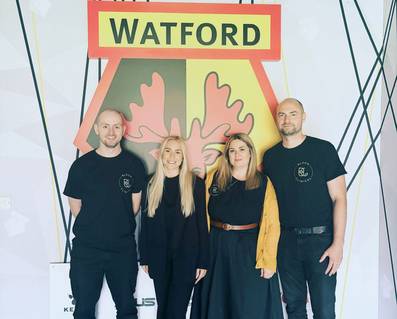 Bloom Clinical staff posing infront of the Watford FC badge